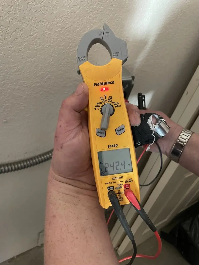 Voltage testing with clamp meter during Recessed Lighting Installation in Raymore